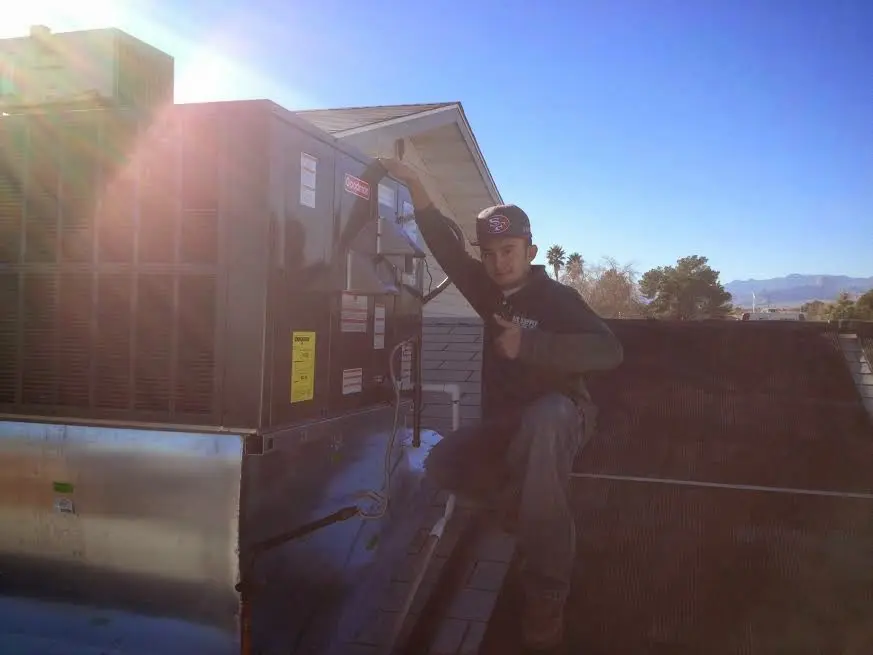 HVAC technician performing HVAC Inspection on a rooftop unit in Duanesburg